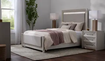 A bedroom with a light-colored bed, lighted headboard, two nightstands, and lamps