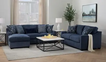 Blue sectional, sofa, coffee table, and end tables in a bright living room