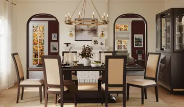 Dining room with dark wood table, cream chairs, gold chandelier, and arched doorways