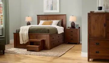 Bedroom with wooden storage bed, steps, bedside tables, lamps, and tall dresser