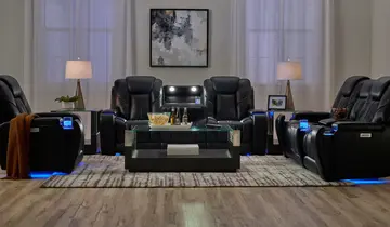 Black leather reclining furniture set with blue LED lighting in a living room