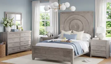 Light gray wood bedroom furniture set in a brightly lit room with blue walls