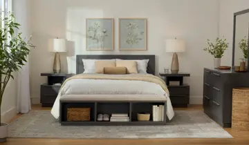 Modern, serene bedroom with gray bed, nightstands, dresser, and bench, white bedding, soft lighting