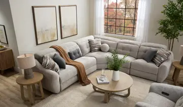 Living room with light gray sectional sofa, coffee table, end tables, and window