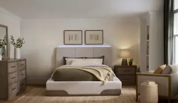 Bedroom with bed, dresser, nightstand, and sitting area