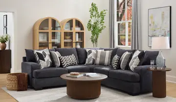Living room with large gray sectional, wooden coffee table, and arched display cabinets