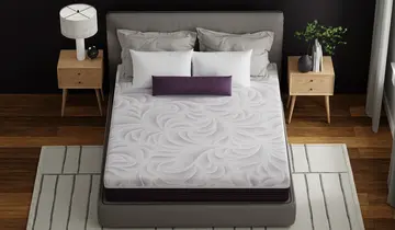 Modern bedroom with a gray bed frame, white patterned mattress, two wood nightstands, and a light striped rug