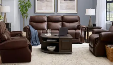 Living room with brown reclining sofa, loveseat, armchair, and dark wood tables