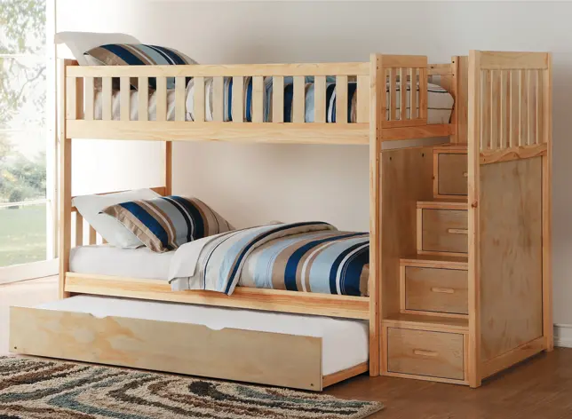 Natural wood bunk bed with stairs, storage drawers, trundle, and blue striped bedding in a bright room