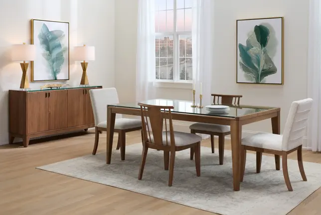 Elegant dining room with a wood and glass dining table, upholstered chairs, wooden buffet, and leaf artwork