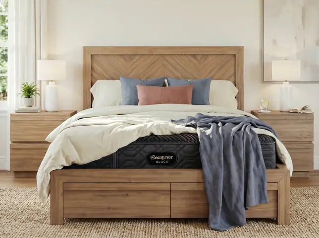 Spacious bedroom with a wooden bed, black mattress, layered bedding, matching nightstands, and soft lighting
