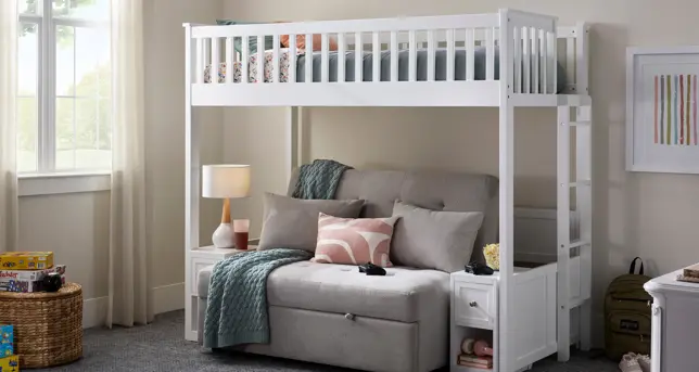 Bright room features a white loft bed positioned above a gray futon, flanked by white side tables