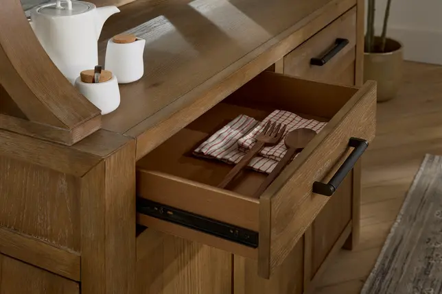 Warm wooden server with an open drawer showing wooden utensils on a checkered napkin, white ceramic pots on top